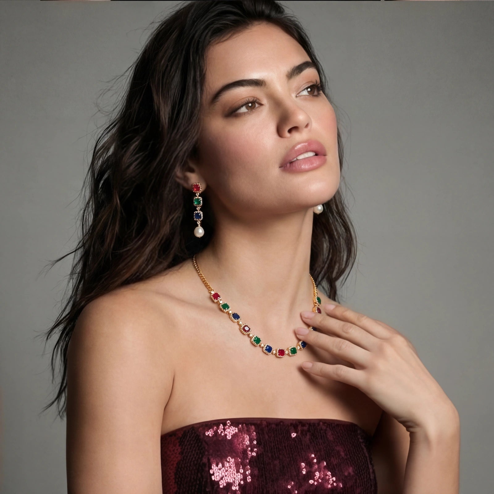Model showcasing the Jewel Royalty Set, featuring radiant ruby, emerald, and sapphire stones in a stunning gold-plated design.