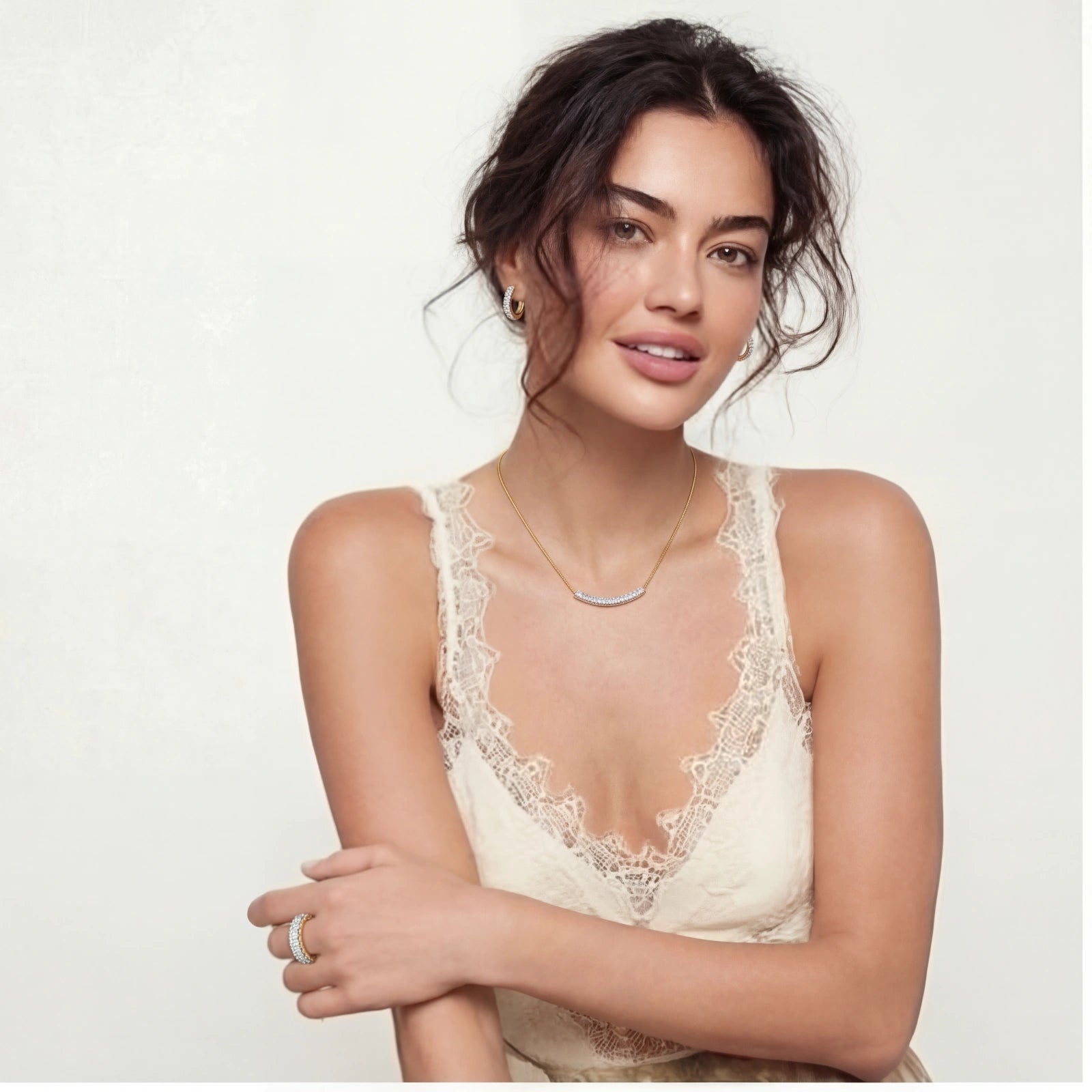 Model showcasing the Crescent Glow Set, featuring a curved necklace, huggie earrings, and an adjustable ring.