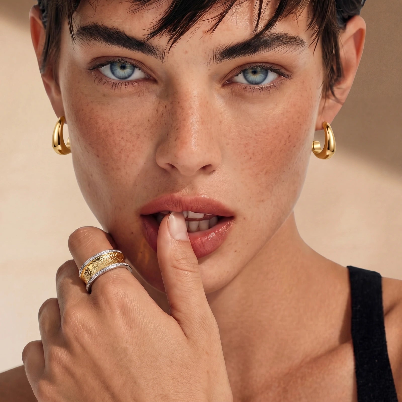 Gold-plated huggie earrings featuring a tapered design that gracefully widens into a sculpted teardrop shape.