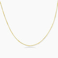 Delicate gold-plated sterling silver chain necklace with geometric segments displayed against cream background