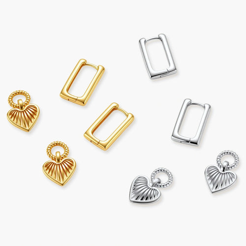 Gold-plated huggie earrings with textured heart charms featuring radiating sunburst patterns on white background.