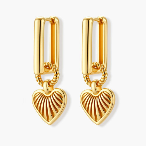 Gold-plated huggie earrings with textured heart charms featuring radiating sunburst patterns on white background.