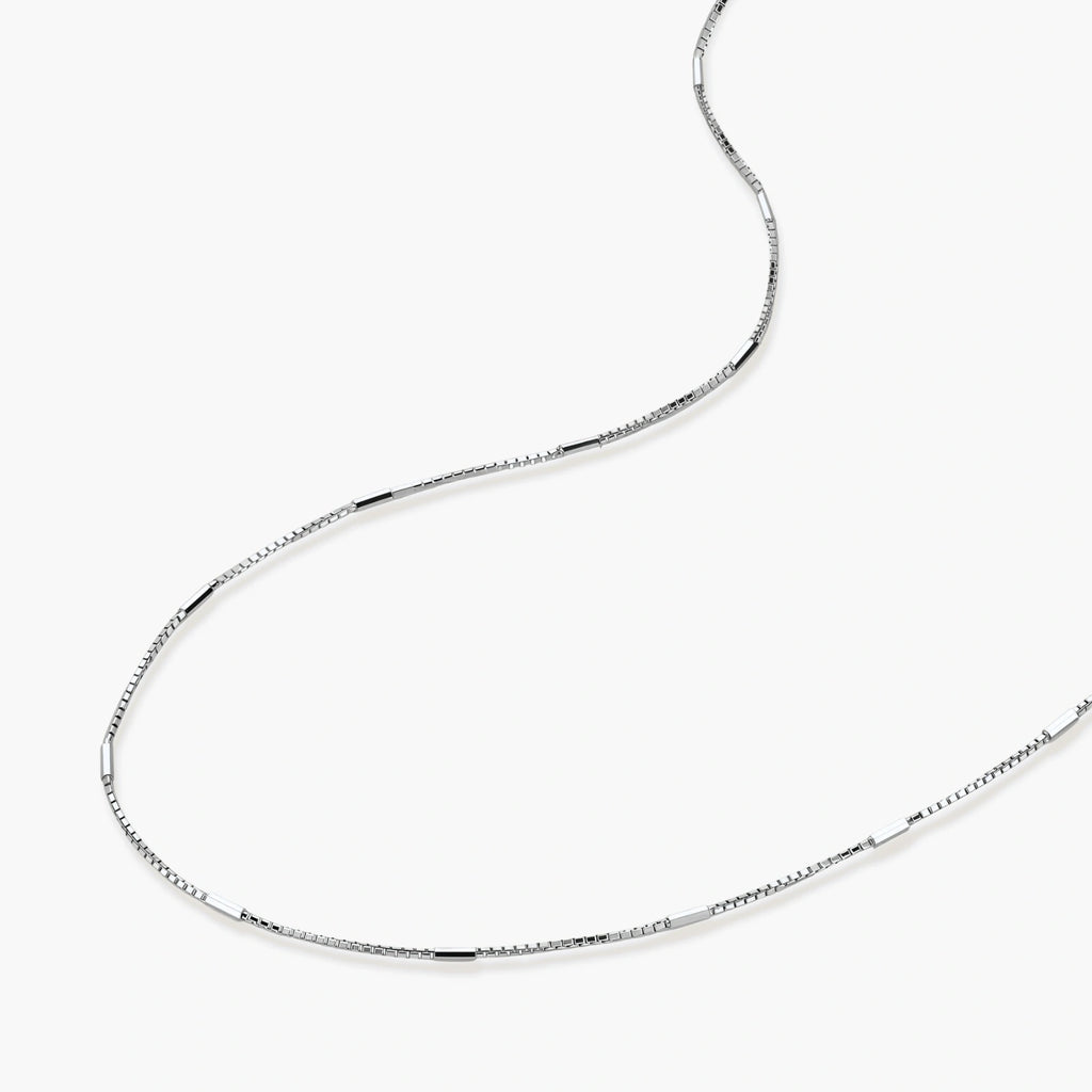 Delicate platinum-plated sterling silver necklace with alternating textured cubic links and smooth chain sections.