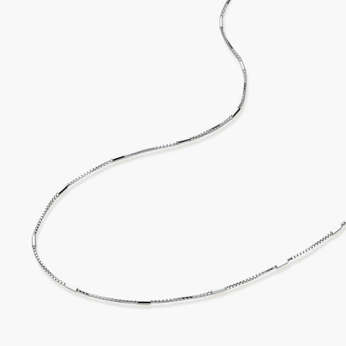 Delicate platinum-plated sterling silver necklace with alternating textured cubic links and smooth chain sections.