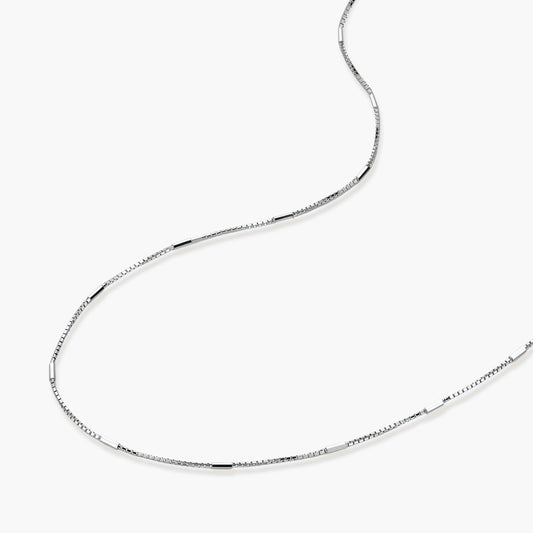 Delicate platinum-plated sterling silver necklace with alternating textured cubic links and smooth chain sections.