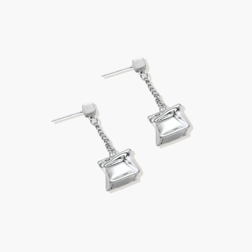 Modern silver dangle earrings with geometric cube pendants and chain design on minimalist background.