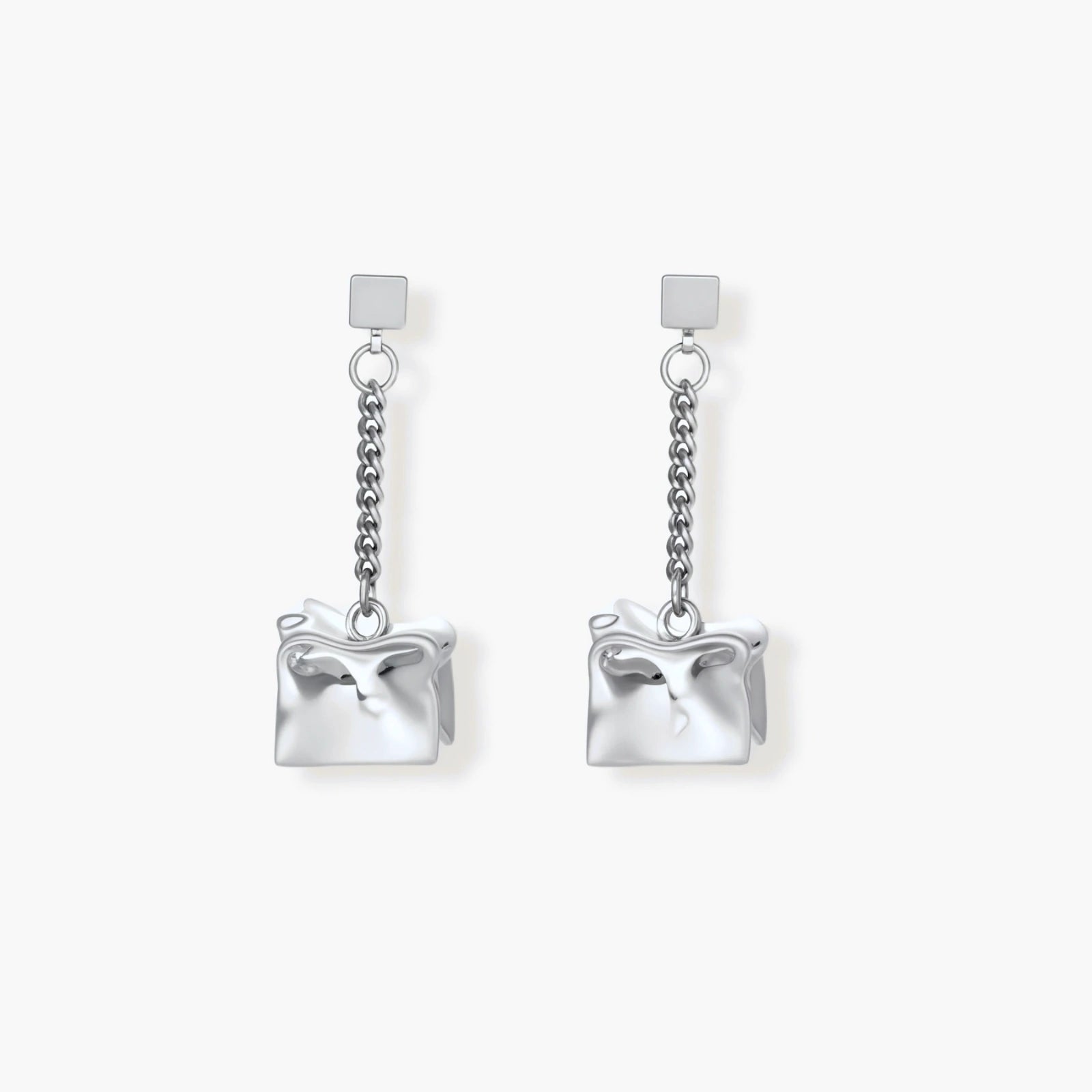 Modern silver dangle earrings with geometric cube pendants and chain design on minimalist background.