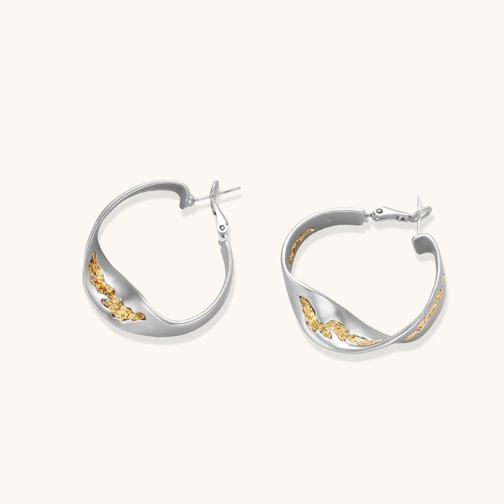 Silver hoop earrings with organic gold flowing accents, featuring eco-zinc alloy construction and secure posts.