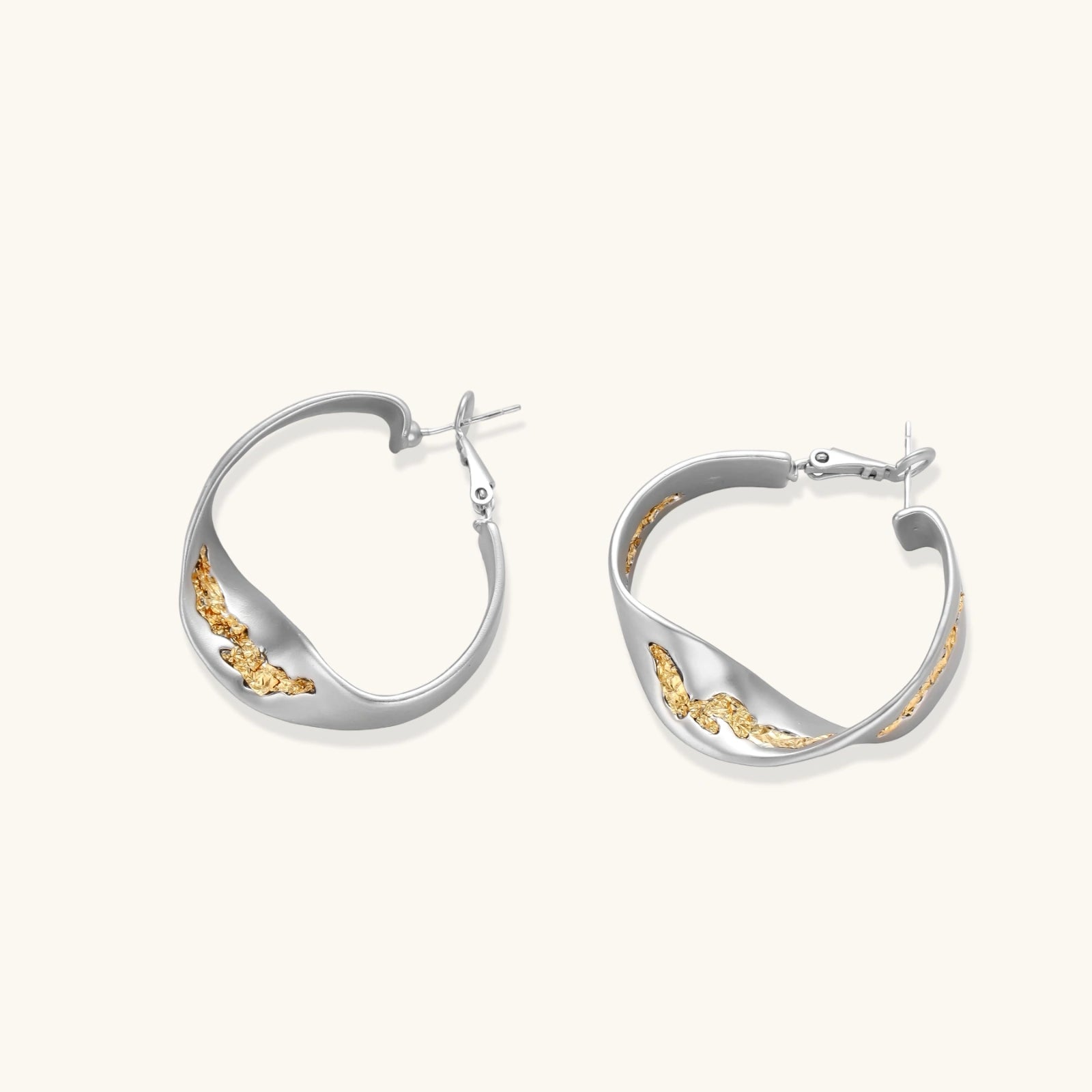 Silver hoop earrings with organic gold flowing accents, featuring eco-zinc alloy construction and secure posts.