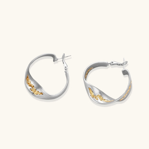Silver hoop earrings with organic gold flowing accents, featuring eco-zinc alloy construction and secure posts.