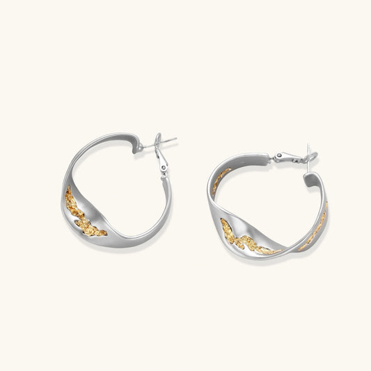 Silver hoop earrings with organic gold flowing accents, featuring eco-zinc alloy construction and secure posts.