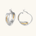 Silver hoop earrings with organic gold flowing accents, featuring eco-zinc alloy construction and secure posts.