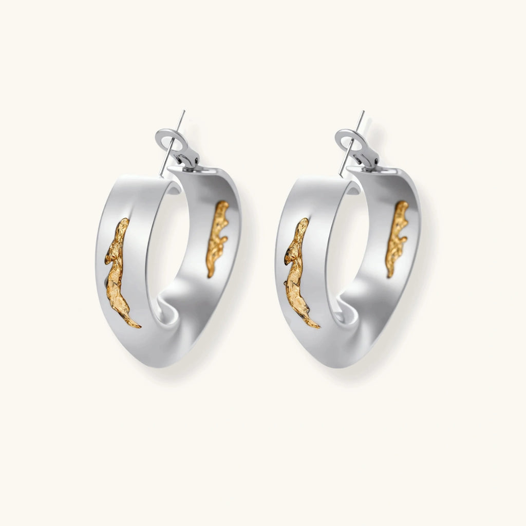 Silver hoop earrings with organic gold flowing accents, featuring eco-zinc alloy construction and secure posts.