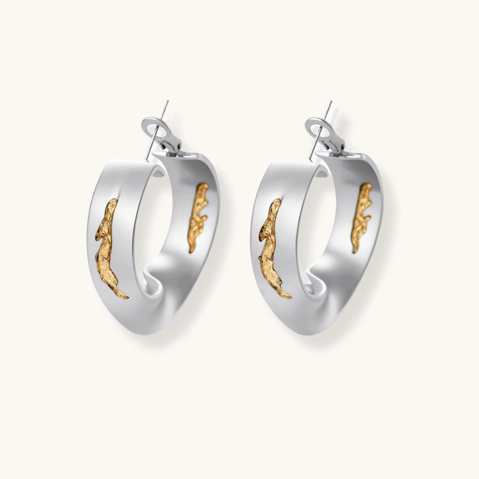 Silver hoop earrings with organic gold flowing accents, featuring eco-zinc alloy construction and secure posts.