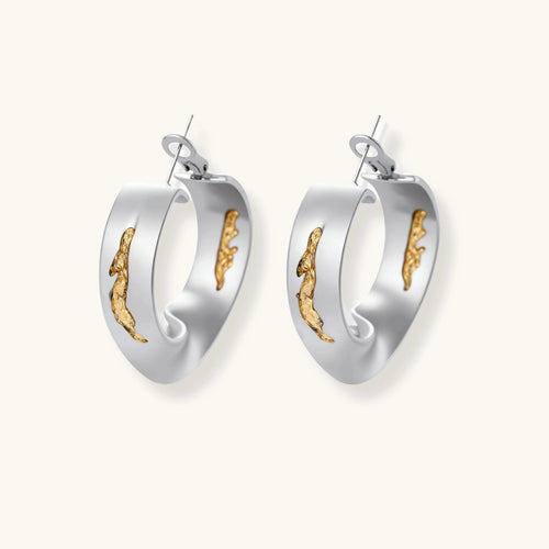 Silver hoop earrings with organic gold flowing accents, featuring eco-zinc alloy construction and secure posts.