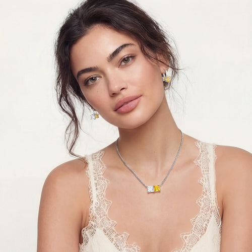 Model showcasing the elegant Duo Crystal Set, featuring a refined curb chain with clear and yellow zirconia stones and matching huggie earrings.