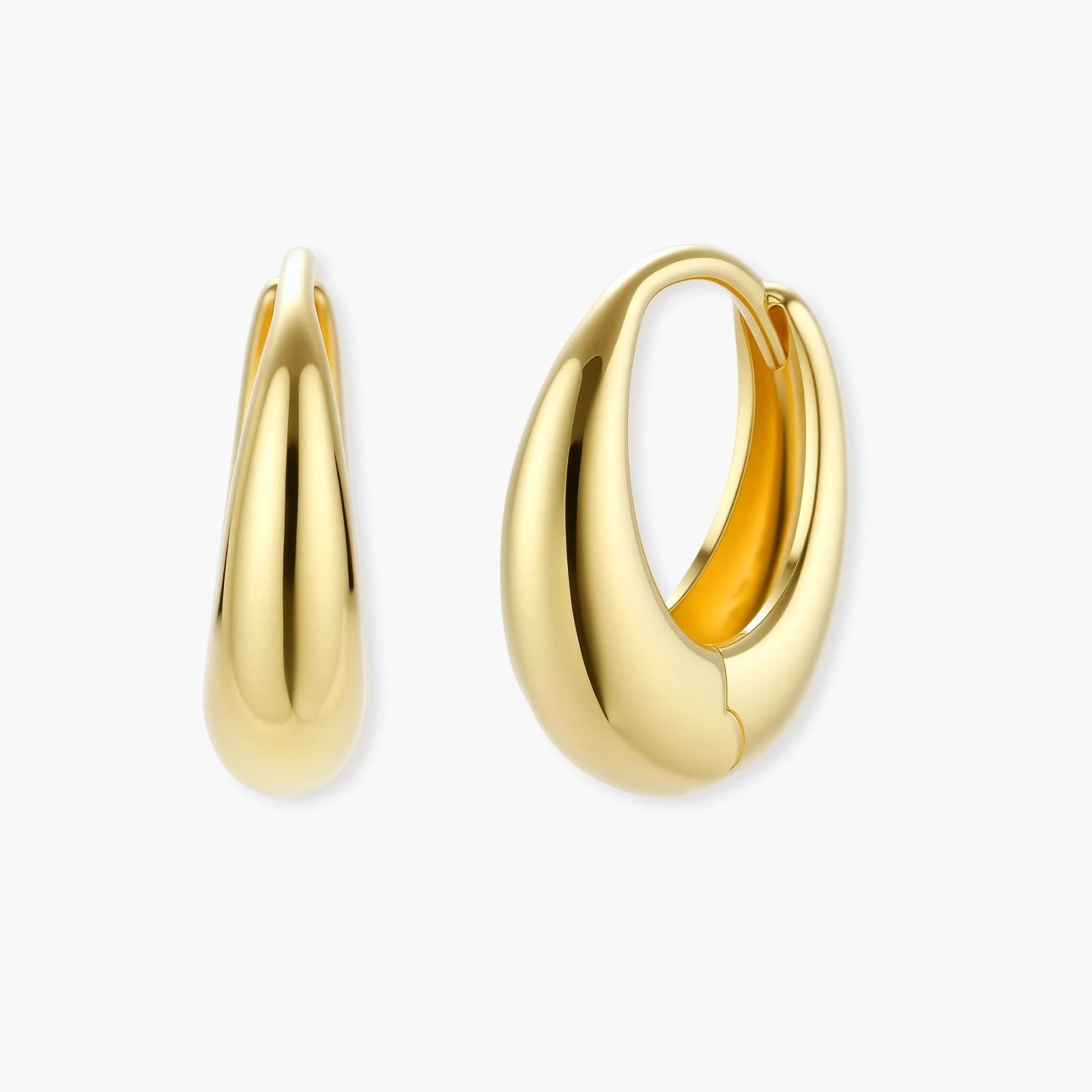 Chunky gold-plated sterling silver huggie hoop earrings with hinged closure mechanism on cream background.
