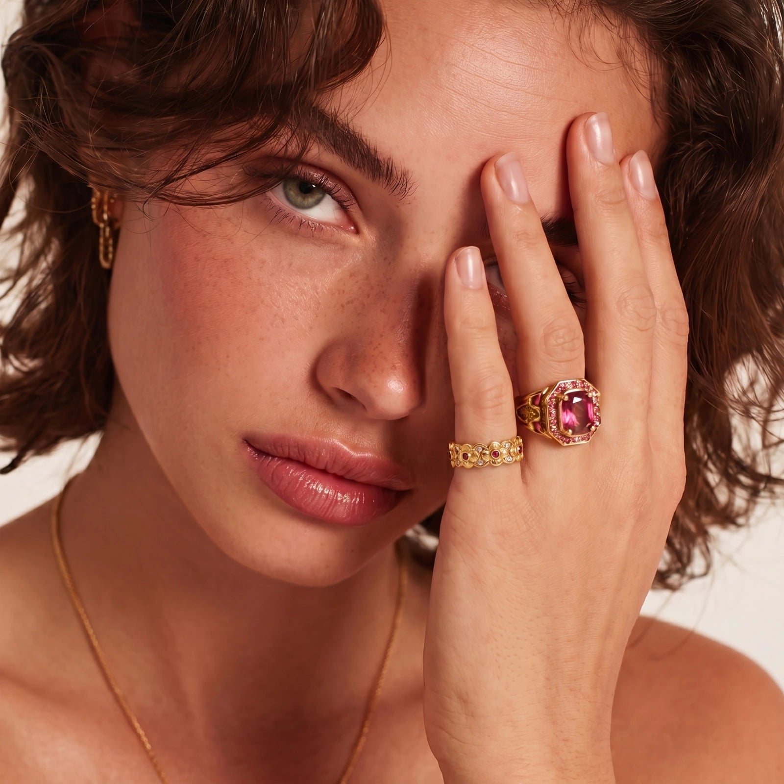 Gold floral ring featuring striking red zirconia centres and clear stone accents, designed with an adjustable band for elegance.