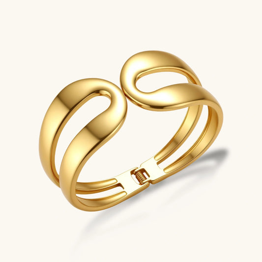 Polished gold cuff bracelet featuring two elegant sculpted loops and an adjustable hinge design.