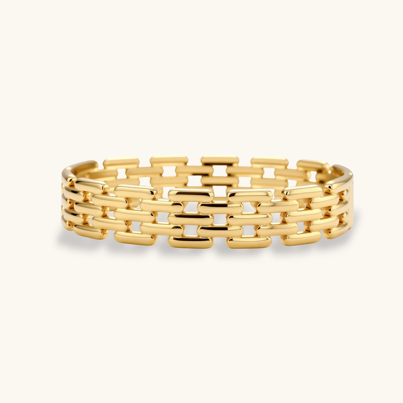 Wide panel-link bracelet featuring three rows of polished gold-toned bars in a grid pattern, exuding modern elegance.