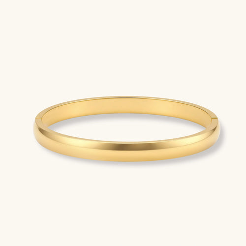 Polished gold hinge bangle with a sleek, minimalist design, perfect for elegant layering or solo wear.