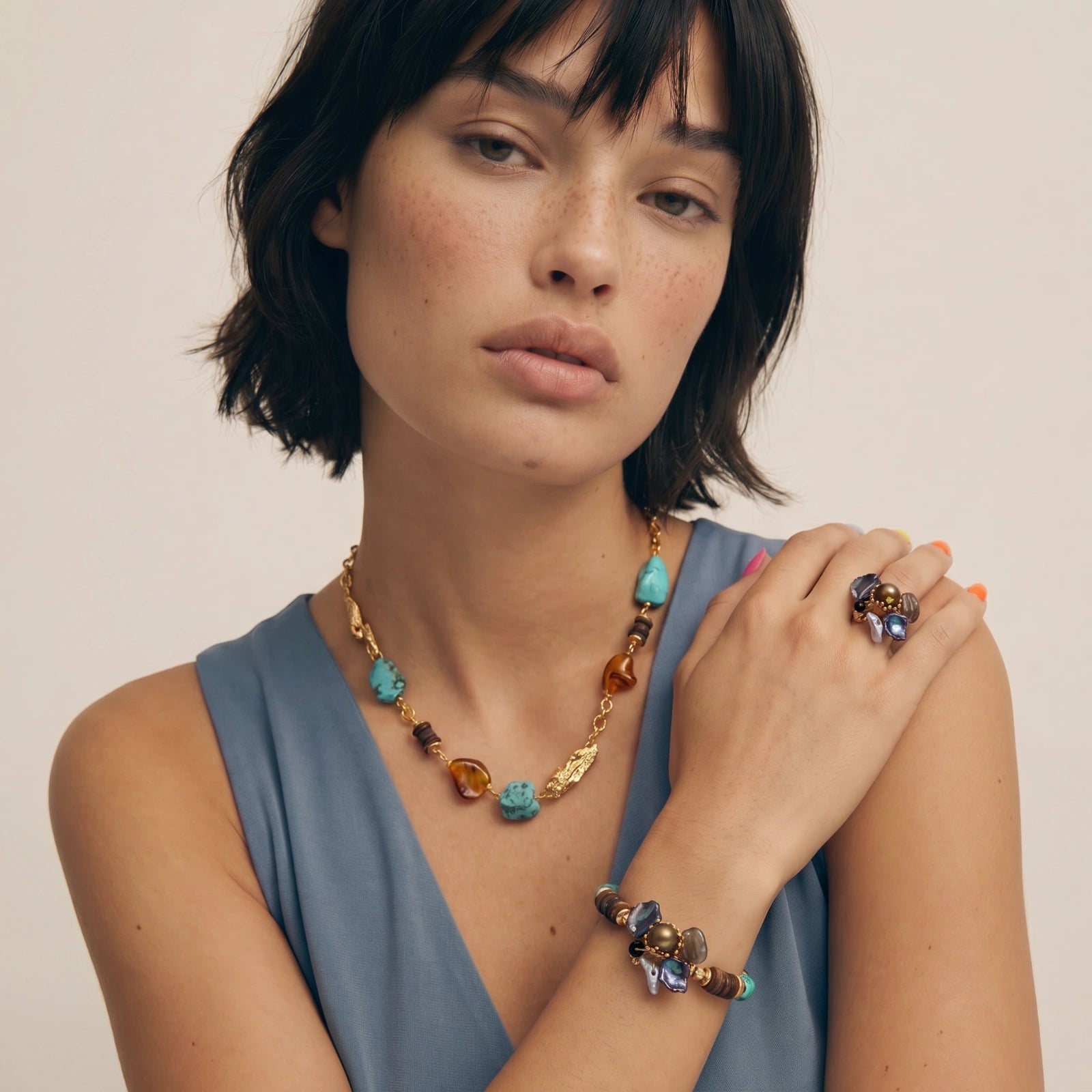 Statement necklace featuring a harmonious blend of turquoise and amber stones, dark wood discs, and gold accents.