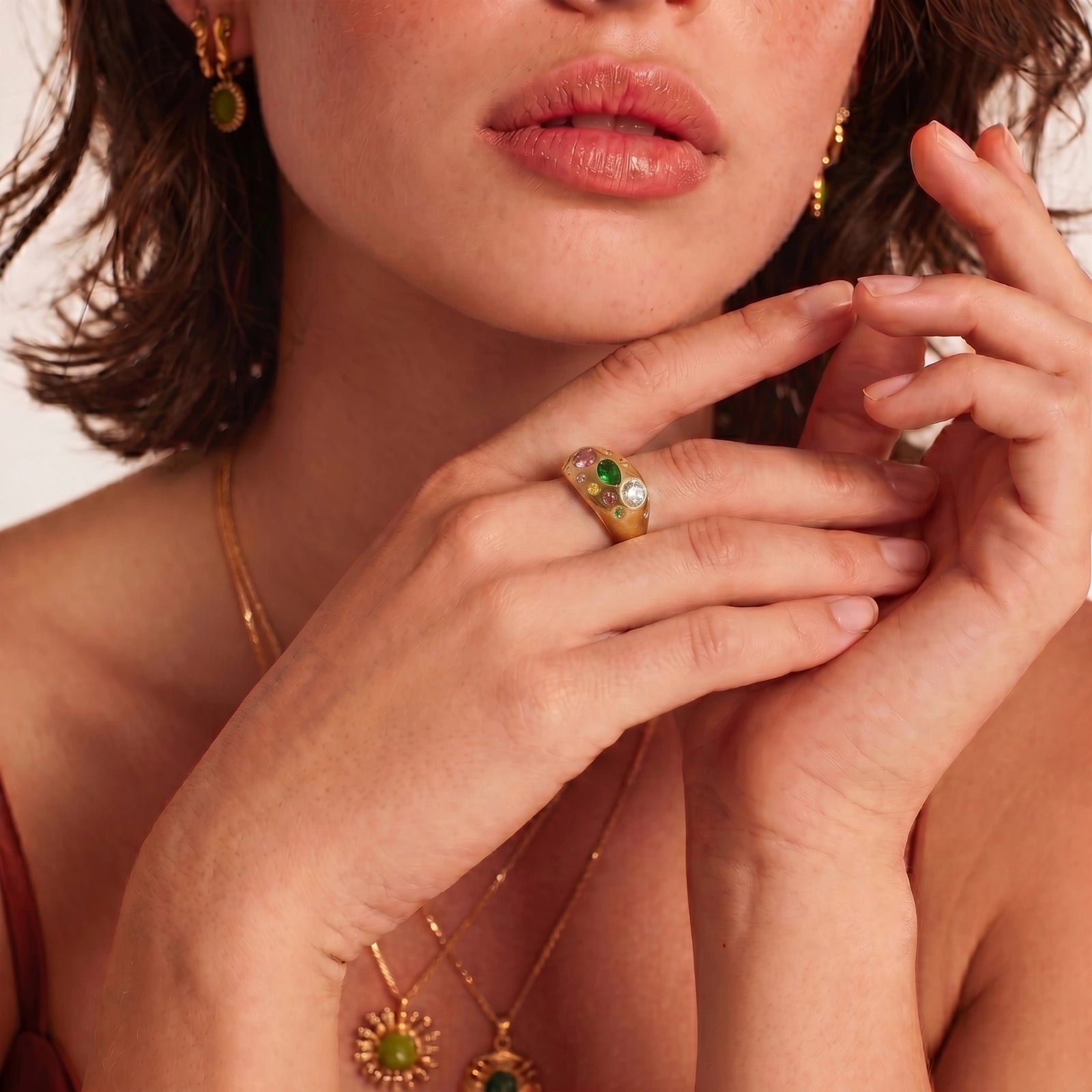 Chunky gold-plated dome ring adorned with vibrant pink, green, red, yellow, and clear cubic zirconia stones.