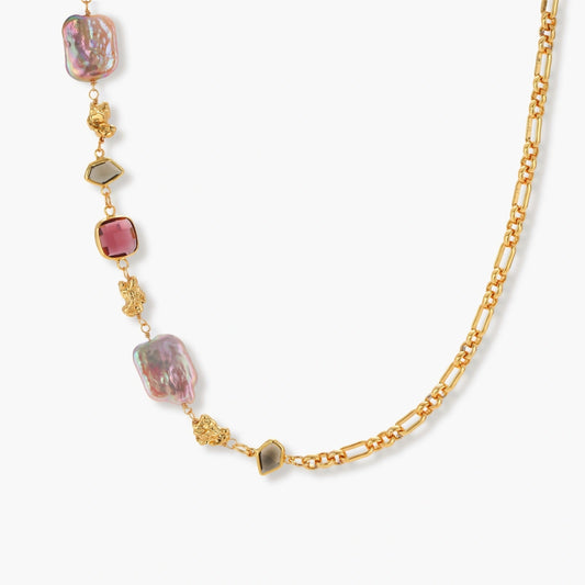 Figaro chain necklace featuring iridescent baroque pearls and a deep raspberry cushion stone, exuding vintage-inspired elegance.