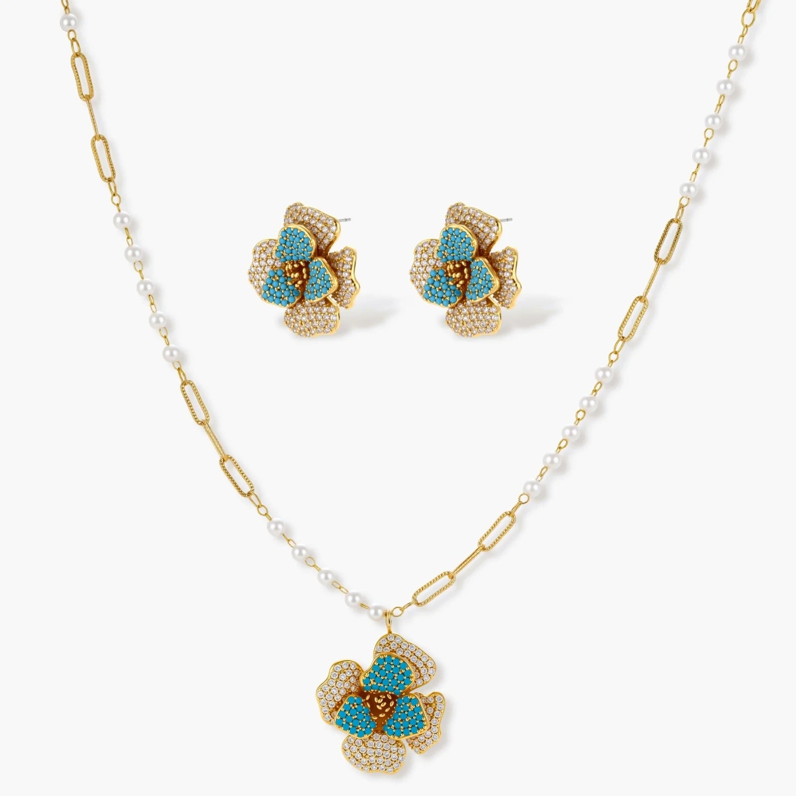 Flower-shaped earrings and pendant necklace featuring turquoise petals, elegantly designed in a luxurious jewellery set.