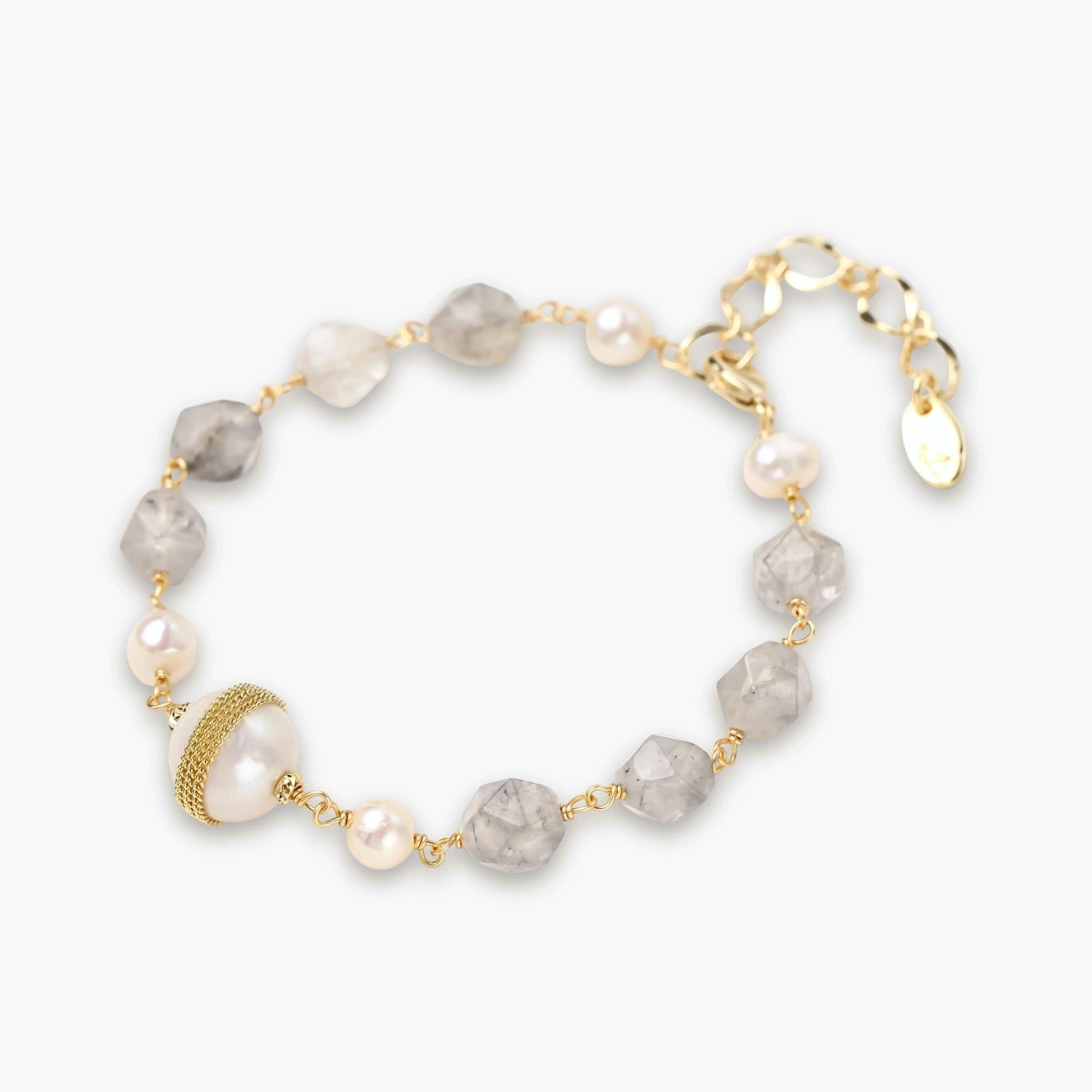 Delicate bracelet featuring round pearls and grey gemstones on a slim gold chain, with an adjustable extender and gold-banded pearl.