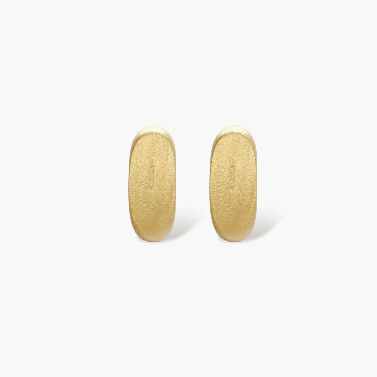 Small gold huggie earrings with matte finish, 14mm diameter, shown against cream background for everyday elegance.