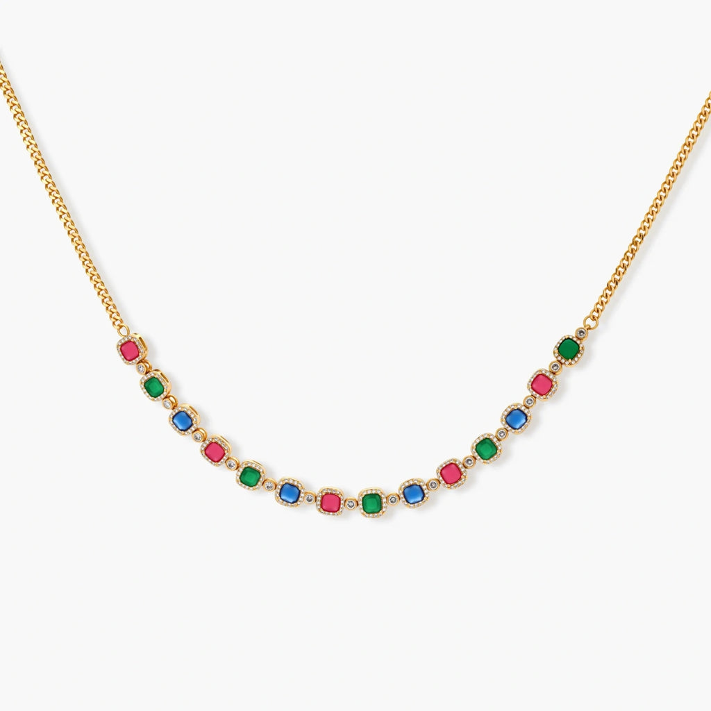 Gold-plated jewelry set with red, green, and blue cubic zirconia stones including necklace, bracelet, and drop earrings.