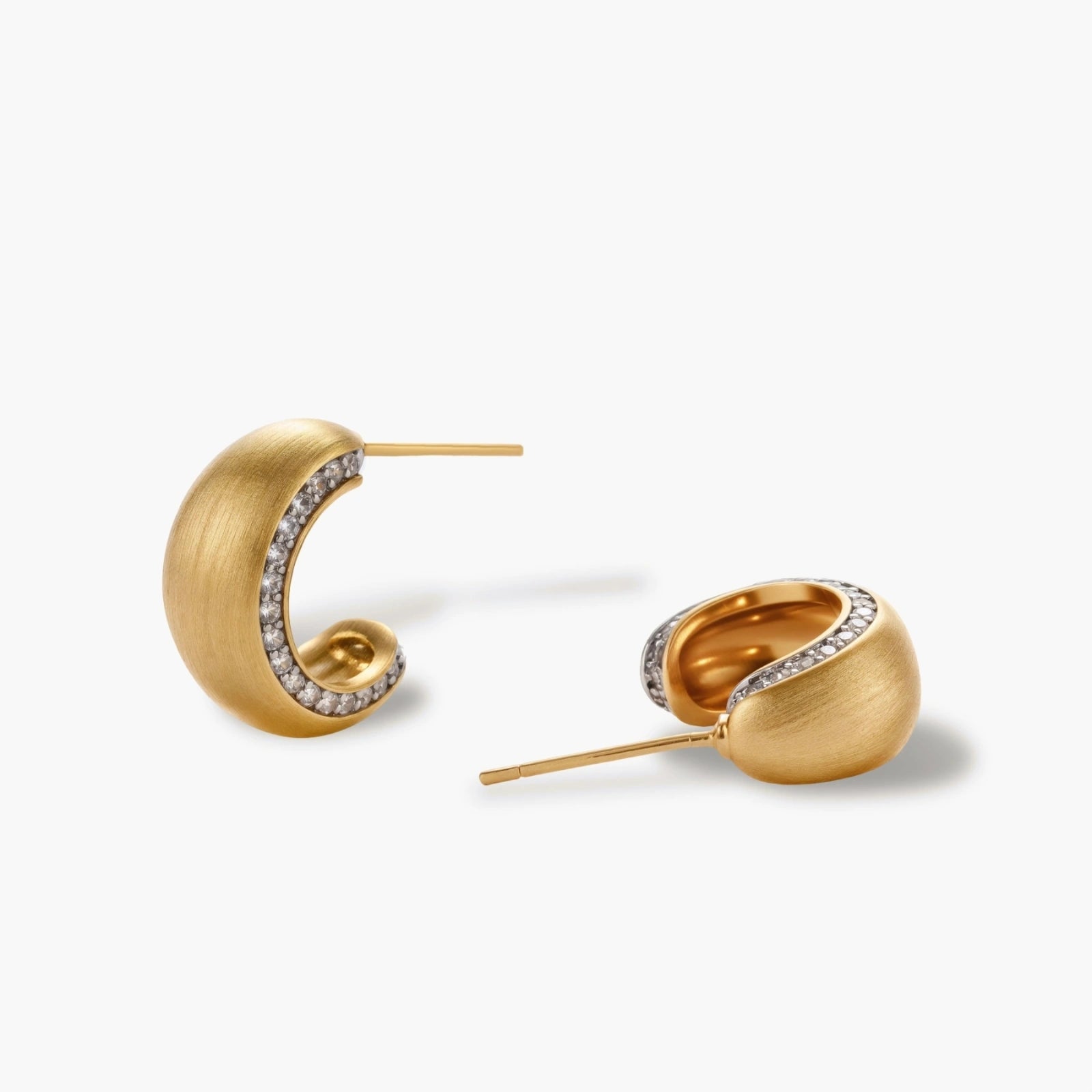 Small gold-plated hoop earrings with crystal accents and brushed finish on white background.
