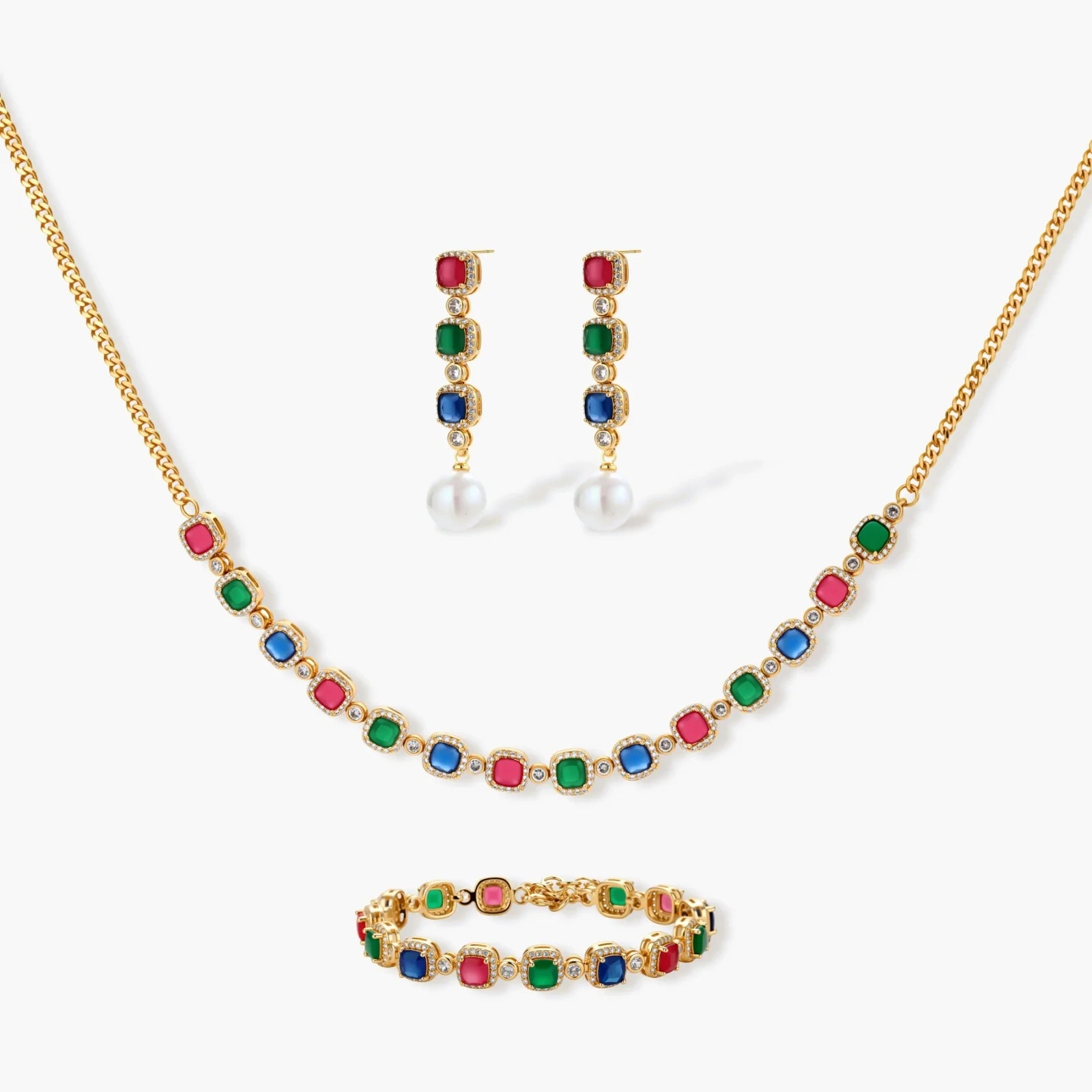 Jewelry set featuring a necklace, earrings, and bracelet adorned with vibrant red, green, and blue stones in gold-toned metal.