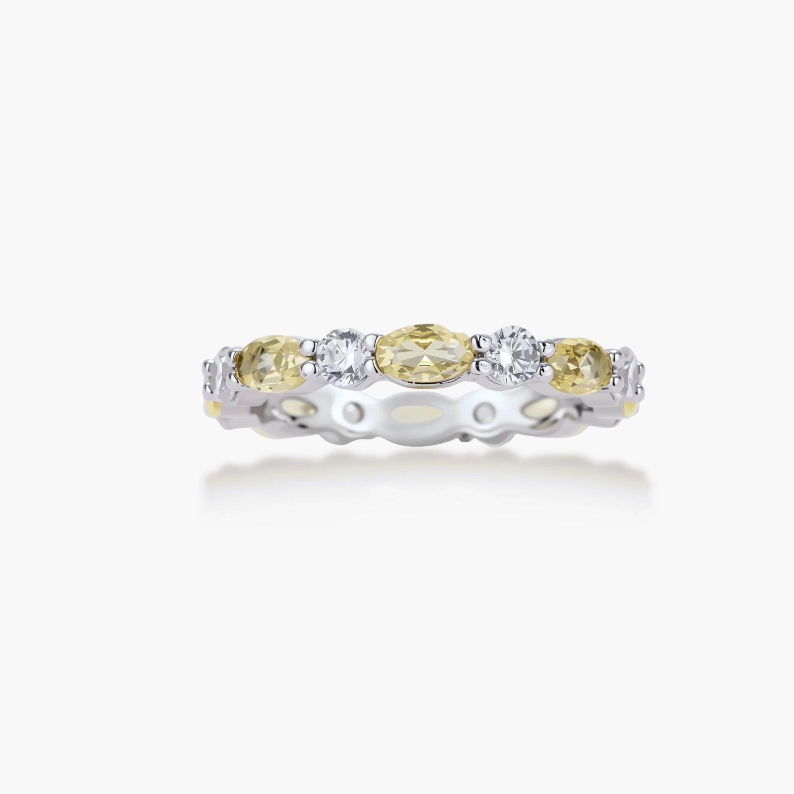 Platinum-plated copper ring with alternating clear and pale yellow oval stones in an eternity band design on white background.