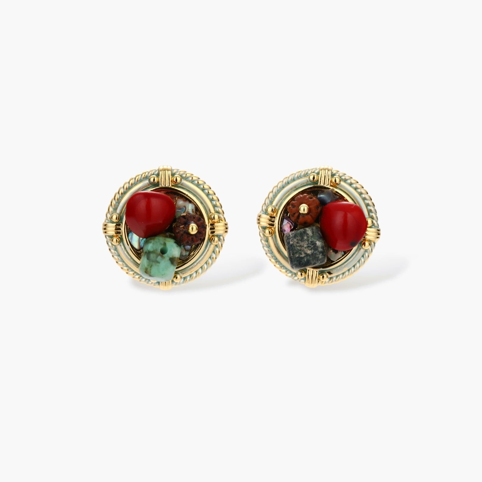 Circular gold-plated earrings with turquoise, coral, wood beads, and rope border detail on cream background.