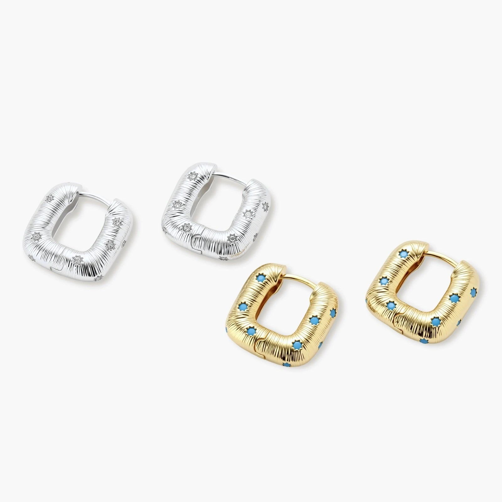 Gold-plated huggie hoop earrings with blue star inlays and textured surface, shown against white background.
