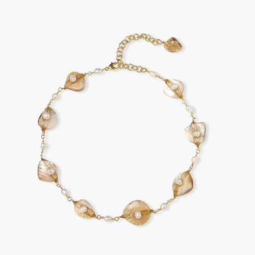 Gold-plated necklace featuring wire-wrapped shell fragments and freshwater pearls, showcasing coastal elegance.