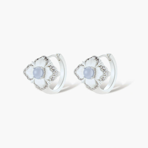 Silver-plated flower earrings with blue zirconia centers, featuring one stud and one huggie hoop in mismatched pair style.