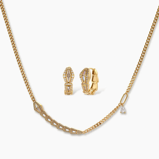 Gold curb-chain necklace paired with coiled snake huggie earrings, both featuring a polished finish.