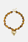 Beaded necklace with naturally shaped beads and a hanging heart
