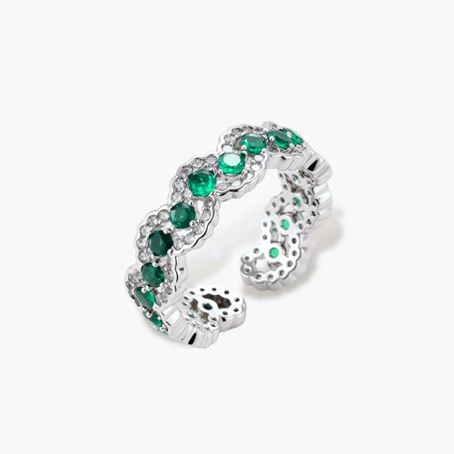 Platinum-plated ring featuring a wave pattern with alternating deep green and clear zirconia stones.