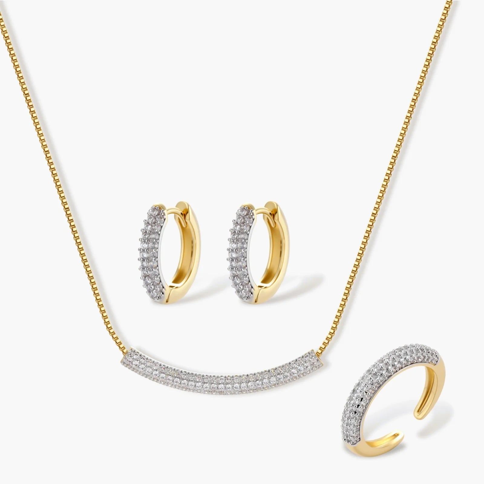 Gold-plated crescent jewellery set featuring a curved pavé bar necklace, huggie earrings, and an adjustable ring.