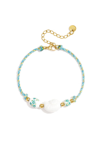 Rope bracelet with shell and floral design beads