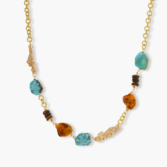 Statement necklace featuring a gold chain, turquoise and amber stones, dark wood discs, and textured gold elements.