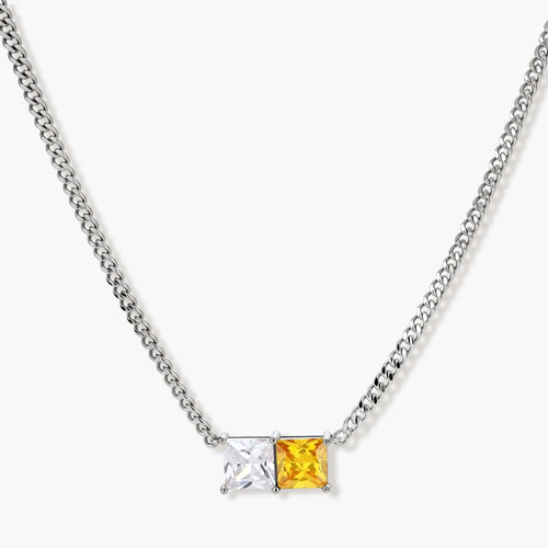 Silver curb-chain necklace and hoop drop earrings set with paired yellow and clear square zirconia stones.