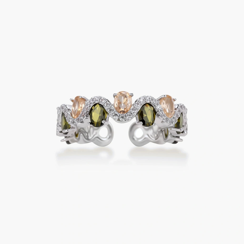Adjustable copper ring with platinum plating, featuring alternating peach and green zirconia stones in organic wave pattern