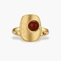 Close-up of brushed 18K gold-plated ring featuring red nanhong stone in geometric square setting with adjustable band