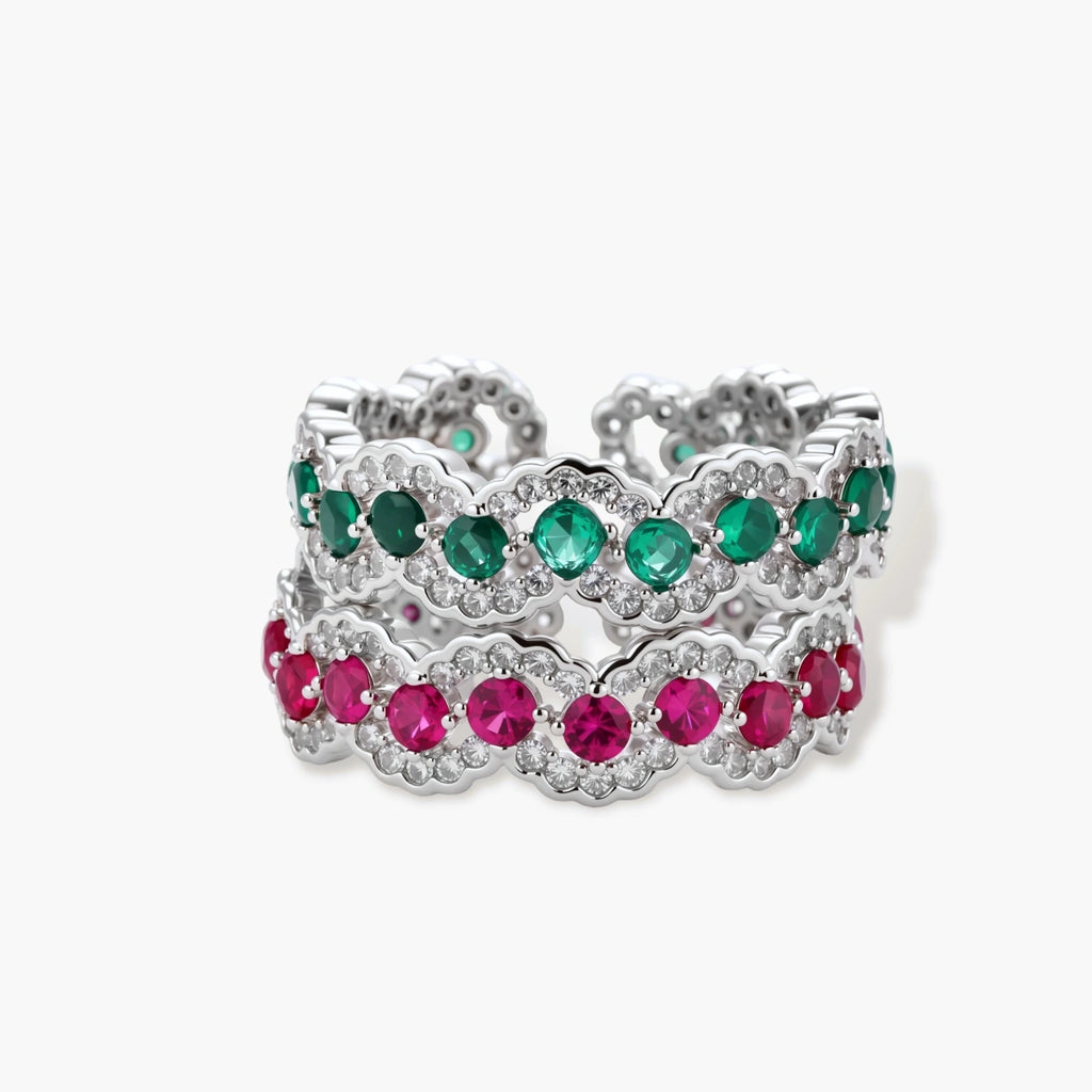 Platinum-plated copper ring with green zirconia stones in decorative scalloped wave pattern, adjustable band design.