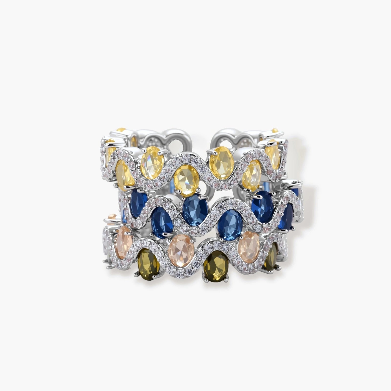Adjustable ring with blue cubic zirconia stones in flowing wave pattern, copper with platinum plating on white background.